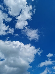 Fototapeta premium A blue sky with puffy clouds.