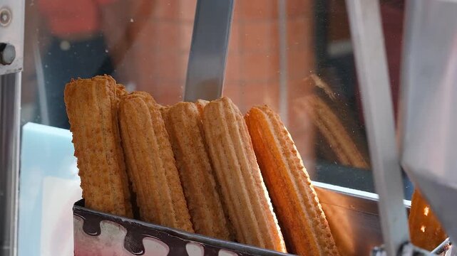 Fried churros waiting to be filled with dulce de leche or chocolate cream_2.