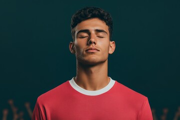 Obraz premium A man in a red shirt is looking at the camera with a calm expression