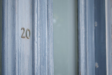 A closeup view of a beautifully designed Blue Door featuring the Number 20 prominently displayed