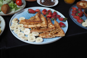 Delicious French Toast beautifully plated with Fresh Fruits on a Vibrant and Colorful Plate