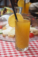 A Refreshing Citrus Drink with an Attractive Garnish Served on a Charming Picnic Table