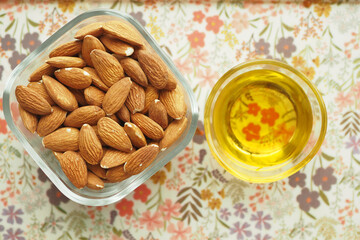 almond oils and fresh nuts on table 