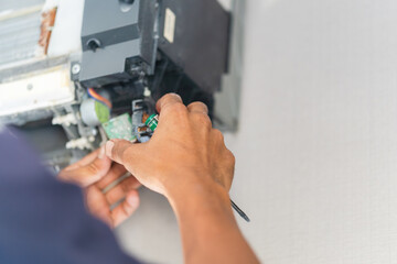 Repairman fixing and cleaning air conditioning system, Air Conditioning Repair, Male technician service for repair and maintenance of air conditioners.