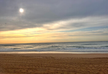Heavenly clouds after a beautiful golden sunrise on a quiet beach in Australia in winter
