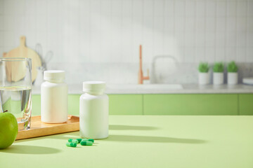 In the kitchen background, on the blue table, medicine boxes are placed with glasses of water and capsules. Front view, space for design and adding text