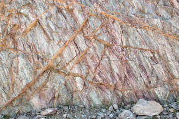 Exposed rock face with detailed geological strata patterns