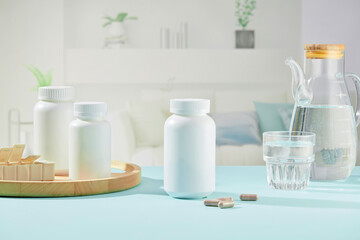Front view of white medicine bottles on wooden tray, glass water cup and capsules decorated on blue table and living room background. Creative scene for advertising