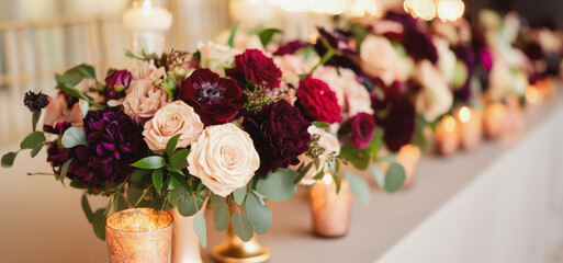 Fototapeta premium Elegant Floral Centerpieces Adorn Wedding Reception Tables With Lush Roses and Candles in Soft Evening Light