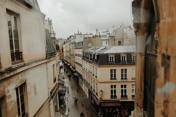 Naklejka premium Paris apartment balcony view of narrow streets and historic buildings on a cloudy day with muted colors.