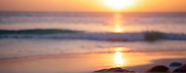 Obraz premium the sun is setting over a rocky shore,