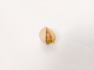 Salted roasted pistachios nut top view in isolated white background. Or Kacang Fustuk usually use...