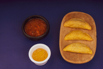 Colombian empanada with spicy sauce 