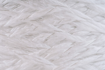 Close-up of intertwined fiberglass strands with visible metal threads, showing the texture and structure of the material.