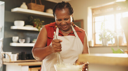Baking, smile and black woman with bowl in kitchen for cake, muffins or dessert at home. Happy, mix and mature African female person with utensil for preparing dough or bread recipe at house.