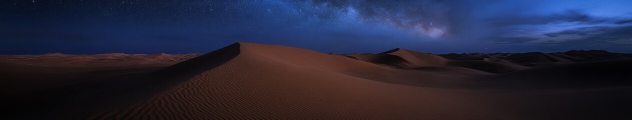 Fototapeta premium Majestic Milky Way Over Vast Desert Dunes: Starry Night Sky Illuminates Pristine Landscape. Cosmic Solitude Captured in Wide-Angle, Long Exposure Astrophotography. Ethereal Moonlit Scene for Nature, S