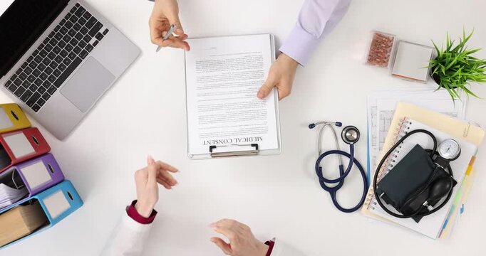 Man studying signing informed consent in doctor office top view