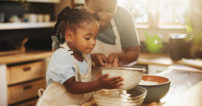 Learning, child and black woman in kitchen for baking, recipe or cake ingredients at home. Girl, development and mother at counter for growth, teaching or fun activity for making dough for cookies