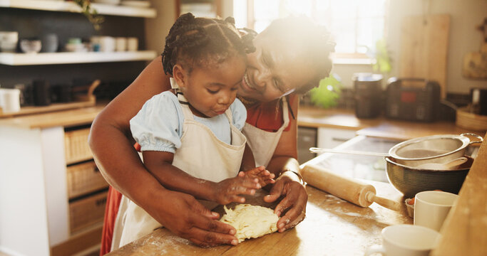 Black woman, child and teaching with dough, cooking and nutrition for support, love and education. Grandmother, girl and baking for development, growth and kitchen as happy family in bonding in home