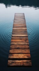 Obraz premium Wooden pier extending into calm lake creating