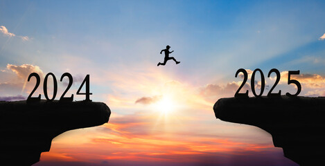 Silhouette man jump between 2024 and 2025 years. Happy new year 2025 concept for achievement.
