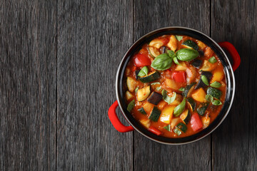 hearty italian vegetable stew in red pot, top view