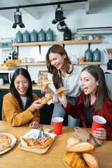 Group of women. Girls are eating pizza or bread in the kitchen.
