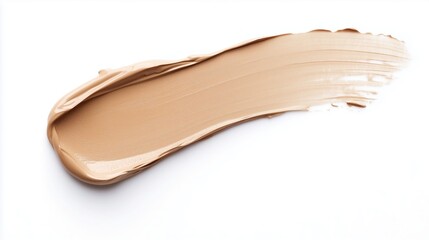 A creamy layer of beige foundation smeared on a white surface to demonstrate cosmetic texture and application technique
