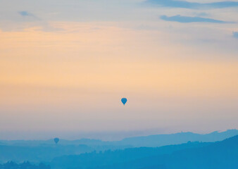 Beautiful orange autumn sky in sunrise and silhouette hot air balloons, hot air balloons at sunrise.