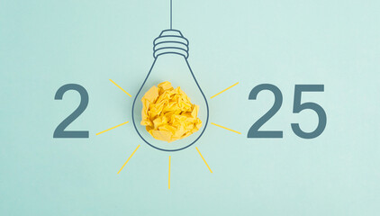 New Year 2025 with a lightbulb, development and growth, being innovative, starting a business, eduaction goal