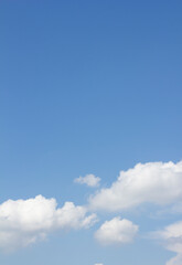 It is a blue sky with puffy clouds.