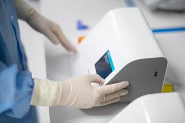 Lab technician starting a point-of-care covid-19 virus testing m