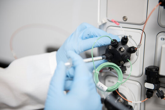 Scientist making adjustments to a machine in a biotech lab