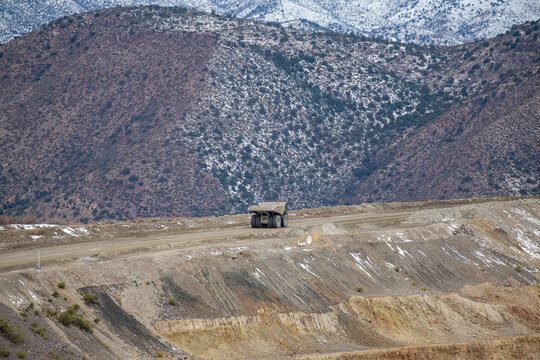 Heavy duty industrial dump truck driving on mountain mining serv