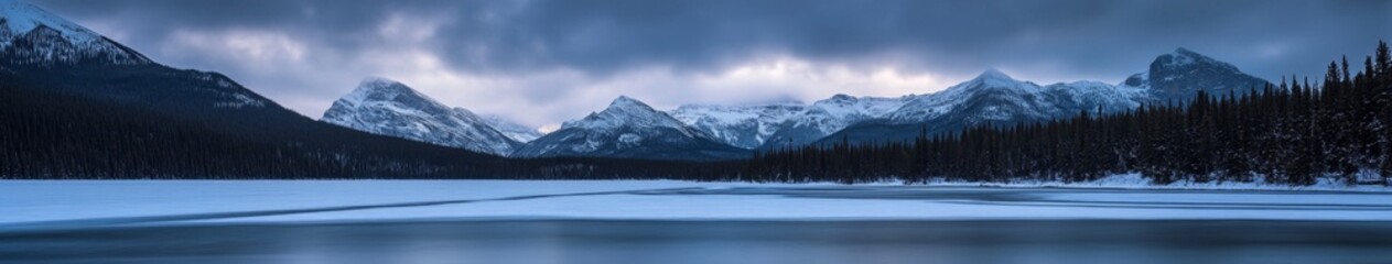 Fototapeta premium Serene Winter Wonderland: Aerial View of Snow-Capped Mountains and Frozen Lake in National Park. Breathtaking Blue Hour Landscape Captures Tranquil Atmosphere and Pristine Nature, Perfect for Travel I