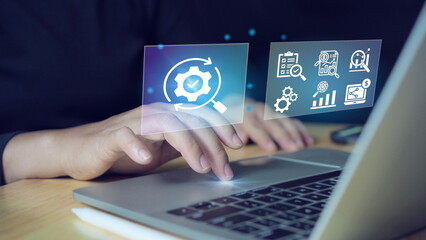 Businessman typing on laptop keyboard showing cogwheel virtual screen. concept of using automation technology To increase efficiency.Automation concept.