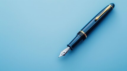 Fototapeta premium A close-up of a classic steel pen placed on a blue background, highlighting elegance and simplicity