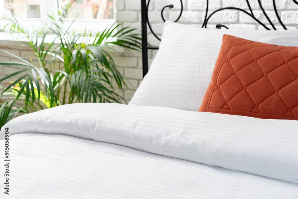 Sticker White Bed With Orange Pillow And Quilted Blanket In Modern Bedroom