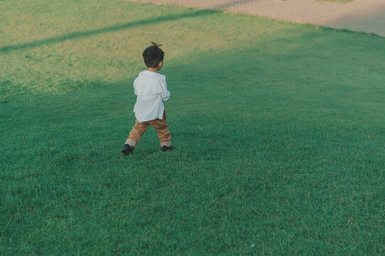 Happy Asian boy running in the park 