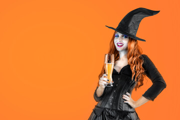 Halloween Witch drinking beer at a beer party. Female wizard fairy character. All Saints' Day. Fantasy gothic red-haired girl in carnival black dress.