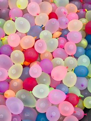 Many small colourful vibrant ballons filled with water