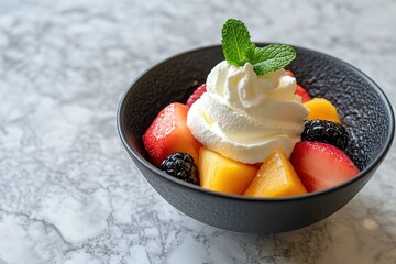 A fresh bowl of fruit topped with a cloud of whipped cream and a mint leaf.
