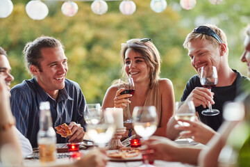 Friends, patio and dinner party with wine, celebration and young people together with pizza....