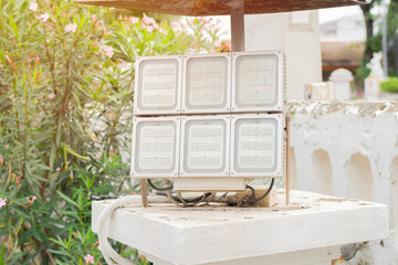 A large rectangular LED floodlight setting under the roof at park of a country side.