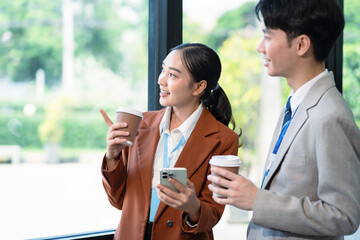 Happy creative business people descent holds a cup of coffee and talking discussion ideas and...
