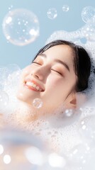 A young woman with closed eyes smiles as she relaxes in a bubbly bath.  The light creates a dreamy atmosphere.  Perfect for spa, relaxation, and beauty products.