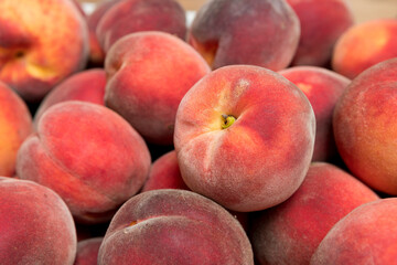 Ripe and juicy peaches in a box
