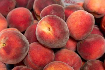Ripe and juicy peaches in a box