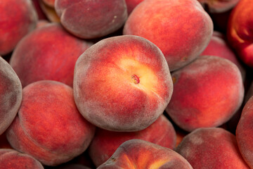 Ripe and juicy peaches in a box
