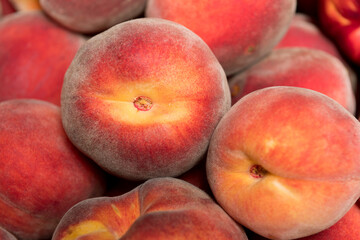 Ripe and juicy peaches in a box